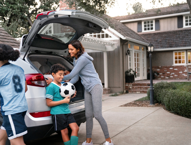 mother packing trunk before soccer game