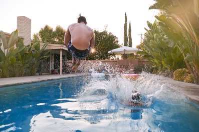man jumping into pool