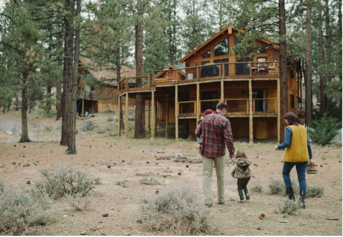 family walking towards cabin