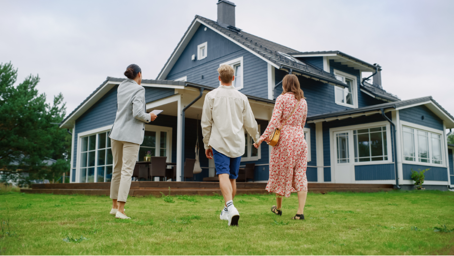 Woman showing a couple a house